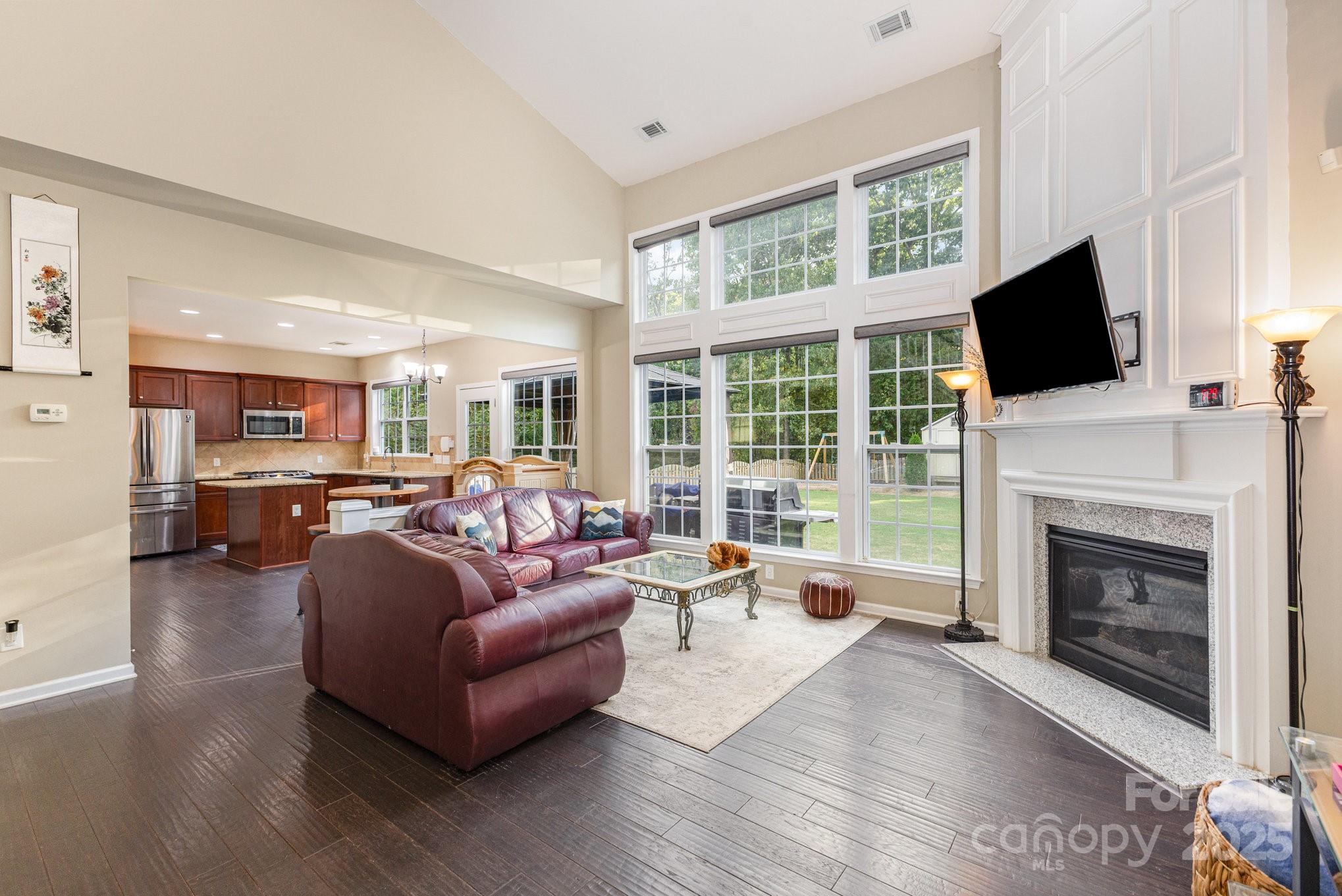 3384 Dunbar Lane Fort Mill, SC 29707 - Photo 10 of 34 a living room with furniture a fireplace and a flat screen tv