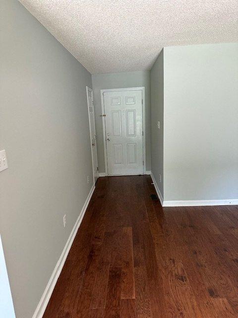 108 Conner Drive Clayton, NC 27520 - Photo 11 of 14 a view of a hallway with wooden floor