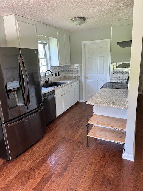 108 Conner Drive Clayton, NC 27520 - Photo 7 of 14 a kitchen with kitchen island a counter top space wooden floor and stainless steel appliances