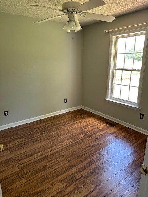 108 Conner Drive Clayton, NC 27520 - Photo 8 of 14 an empty room with wooden floor fan and windows