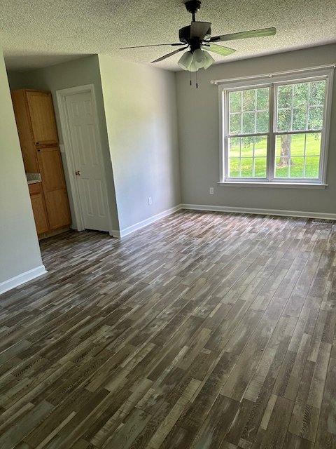 108 Conner Drive Clayton, NC 27520 - Photo 9 of 14 an empty room with wooden floor fan and windows