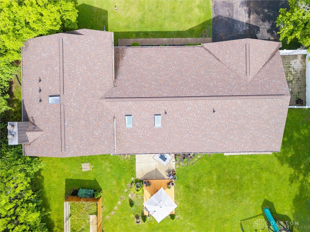 2165 Stewart Road Xenia, OH 45385 - Photo 48 of 59 An aerial view showcases a residential roof with skylights and surrounding green landscaping.