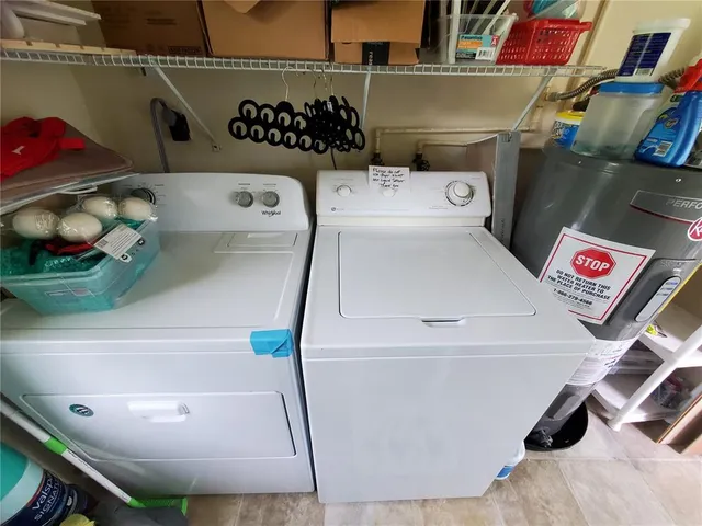 a view of a living room with furniture and floor to ceiling window