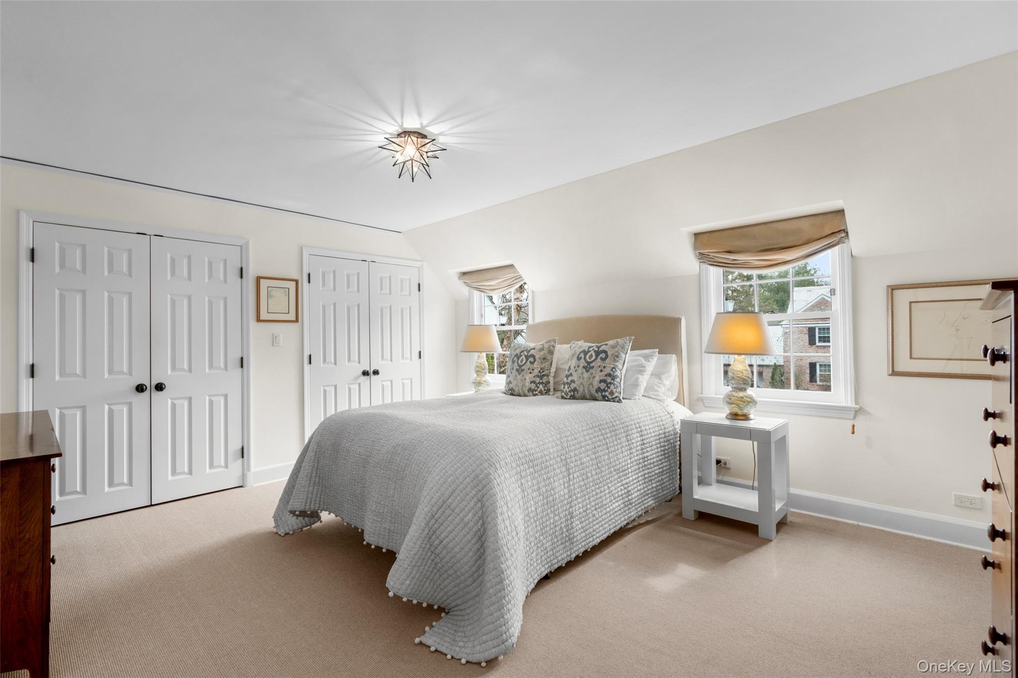 111 Berrian Road New Rochelle, NY 10804 - Photo 15 of 33 a bedroom with a bed and a chandelier