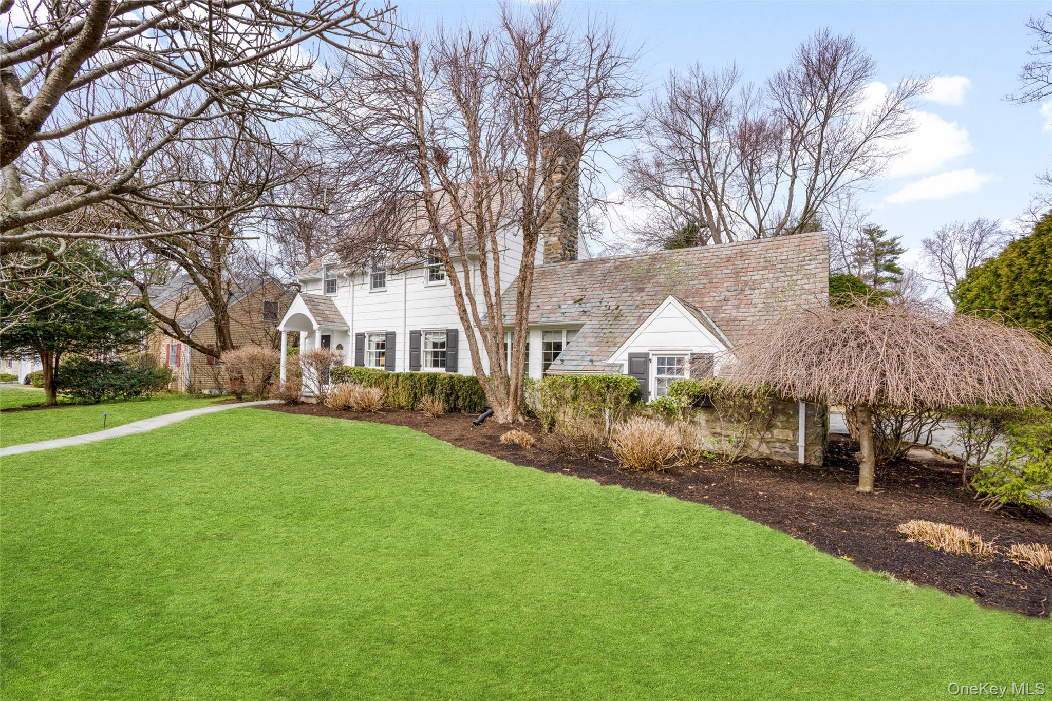 111 Berrian Road New Rochelle, NY 10804 - Photo 2 of 33 a front view of a house with a yard and trees