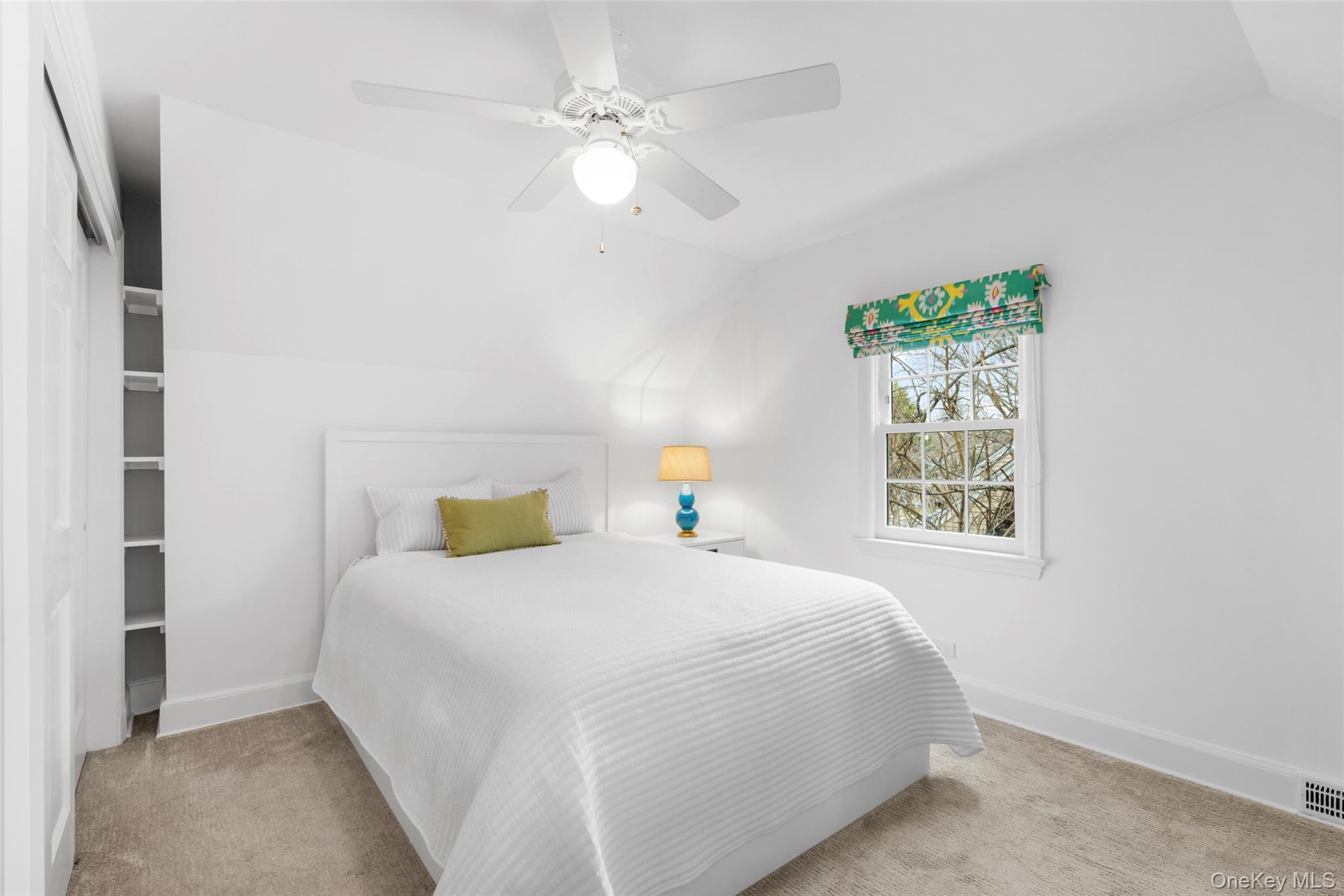 111 Berrian Road New Rochelle, NY 10804 - Photo 22 of 33 a bedroom with a bed a chandelier and a window