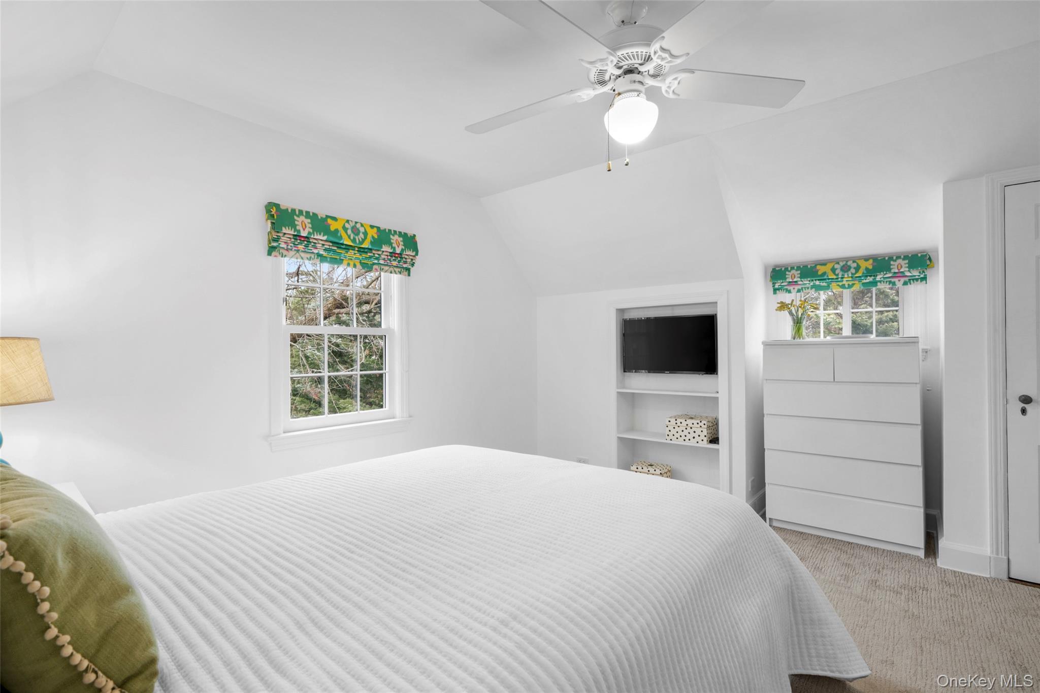 111 Berrian Road New Rochelle, NY 10804 - Photo 23 of 33 a bedroom with a large bed and a chandelier fan