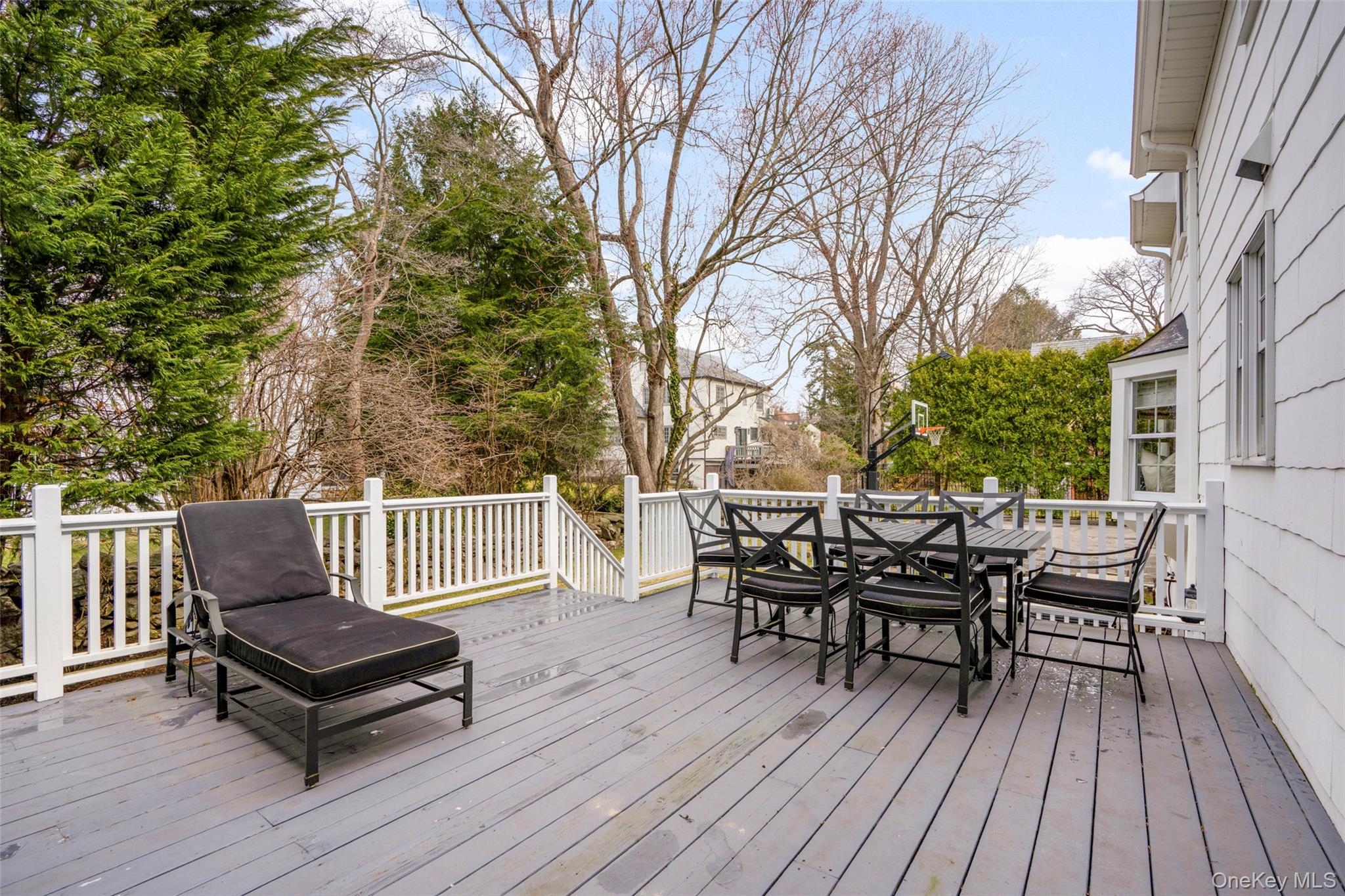 111 Berrian Road New Rochelle, NY 10804 - Photo 25 of 33 a view of a deck with table and chairs and wooden floor