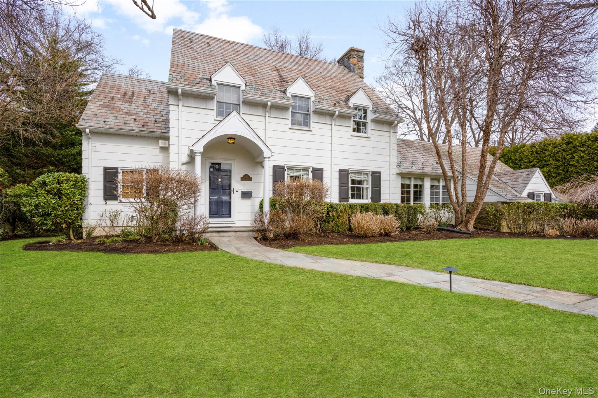 111 Berrian Road New Rochelle, NY 10804 - Photo 29 of 33 a front view of a house with a garden