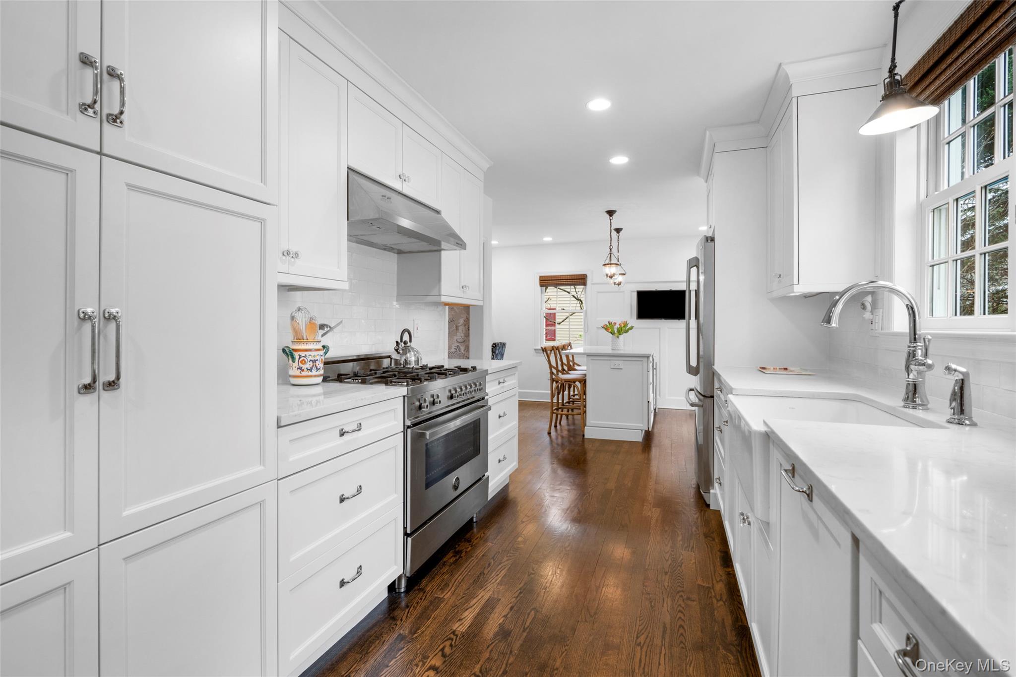 111 Berrian Road New Rochelle, NY 10804 - Photo 9 of 33 a kitchen with white cabinets sink and stainless steel appliances