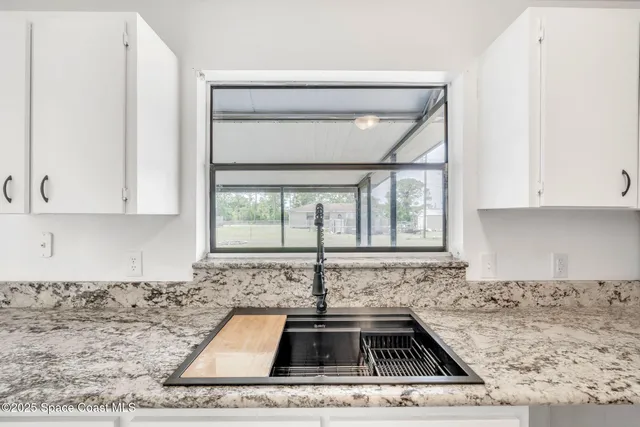 a white stove top oven sitting inside of a kitchen
