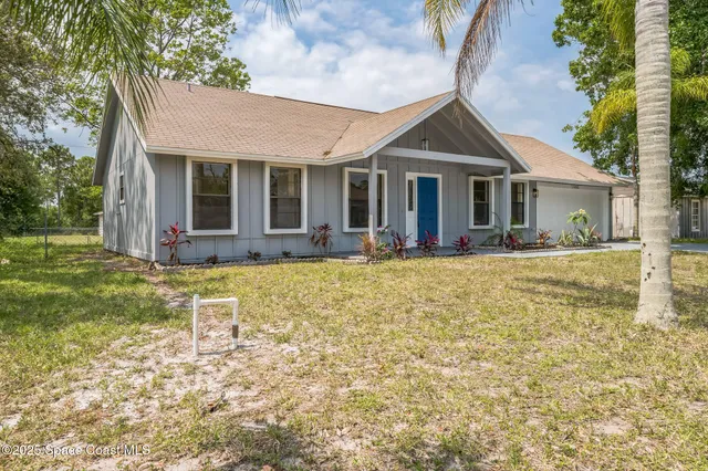 a front view of a house with a yard table and chairs