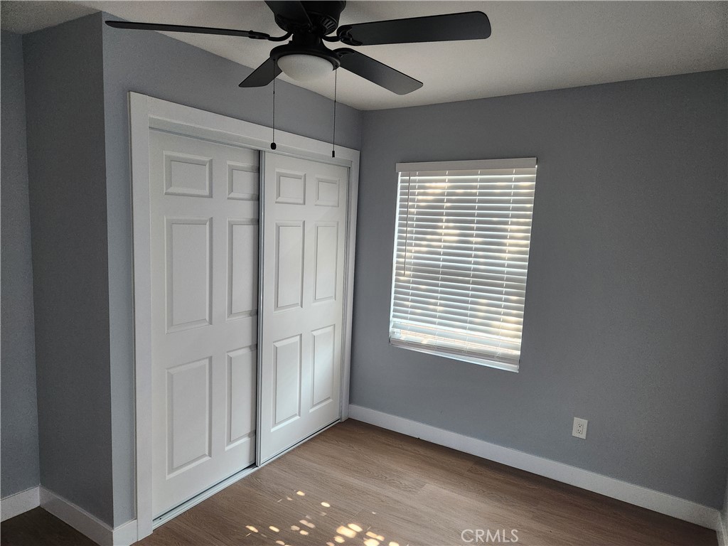 841 East H Street Colton, CA 92324 - Photo 12 of 23 an empty room with chandelier fan and windows