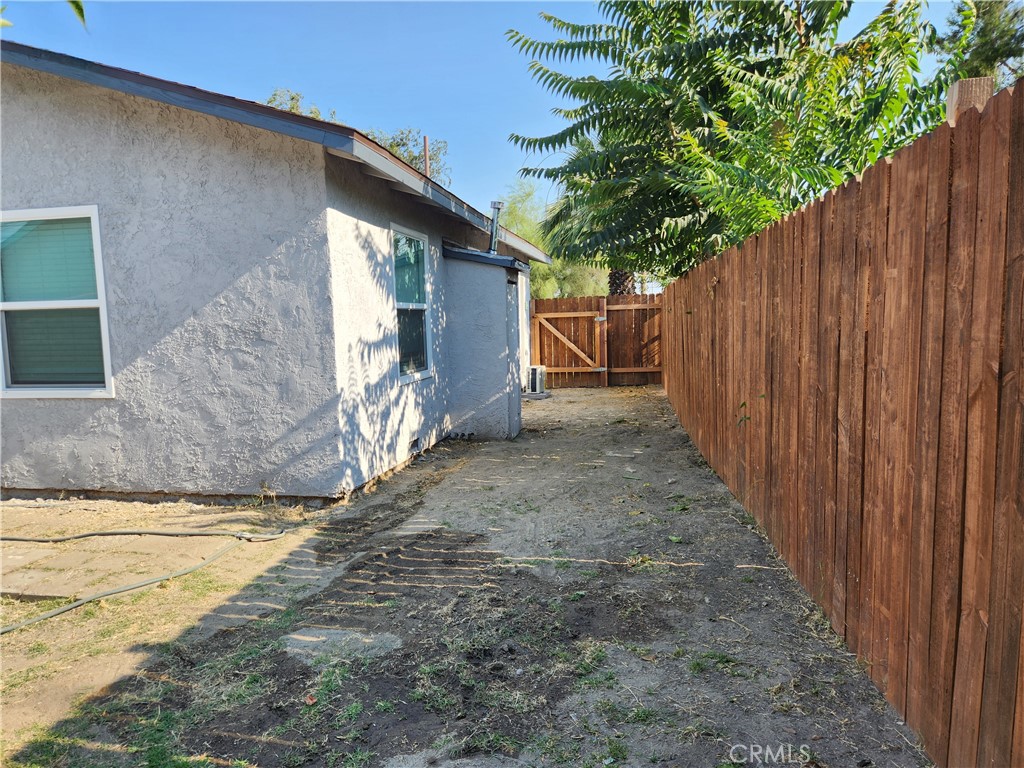 841 East H Street Colton, CA 92324 - Photo 20 of 23 a view of a wooden door with a tree