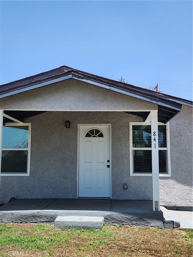 841 East H Street Colton, CA 92324 - Photo 2 of 23 a front view of a house with a garage