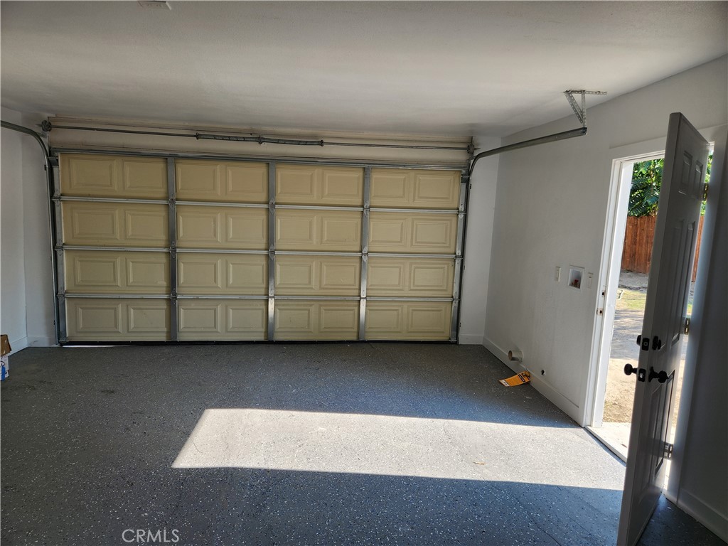 841 East H Street Colton, CA 92324 - Photo 22 of 23 an empty room with a wooden cabinet and mirrors
