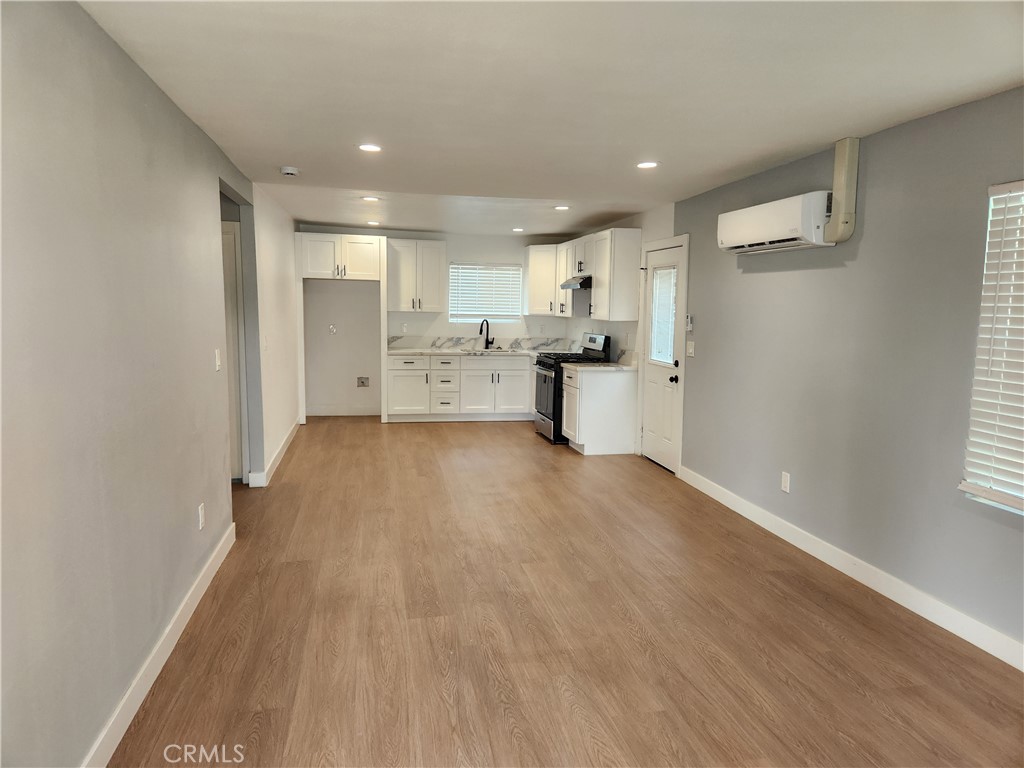 841 East H Street Colton, CA 92324 - Photo 3 of 23 a view of a kitchen with a sink and wooden floor
