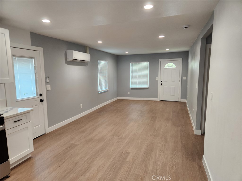 841 East H Street Colton, CA 92324 - Photo 4 of 23 an empty room with wooden floor and window