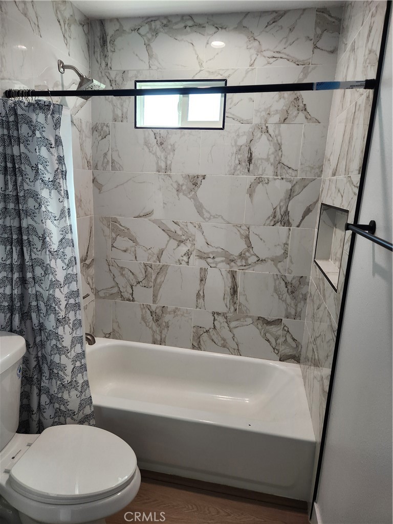 841 East H Street Colton, CA 92324 - Photo 10 of 23 a bathroom with a toilet and a shower