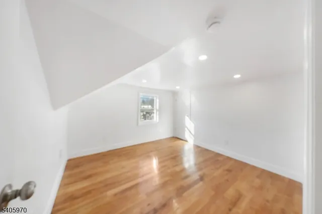 a view of hallway with wooden floor