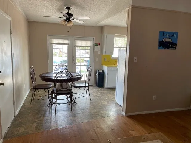 a view of a dining room with furniture and a window