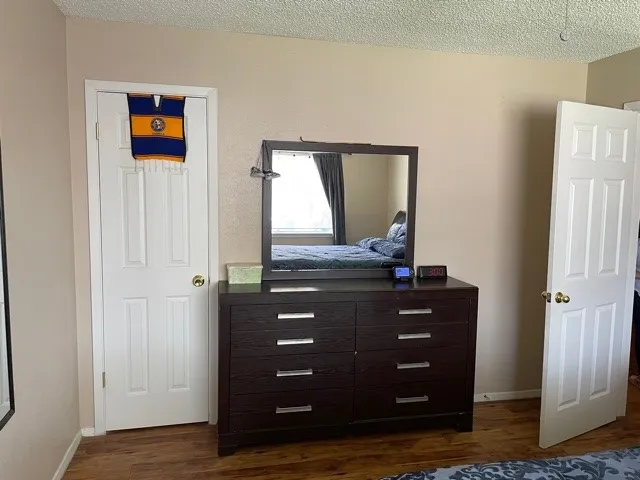 a room with a dresser with wooden floor