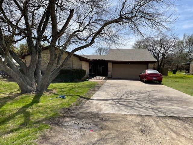 801 Old Austin Pflugerville Road Pflugerville, TX 78660 - Photo 2 of 24 a front view of a house with a yard and garage