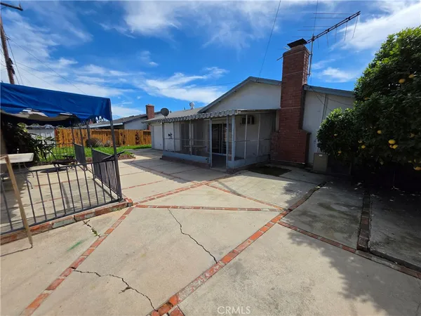 a view of a house with a wooden fence