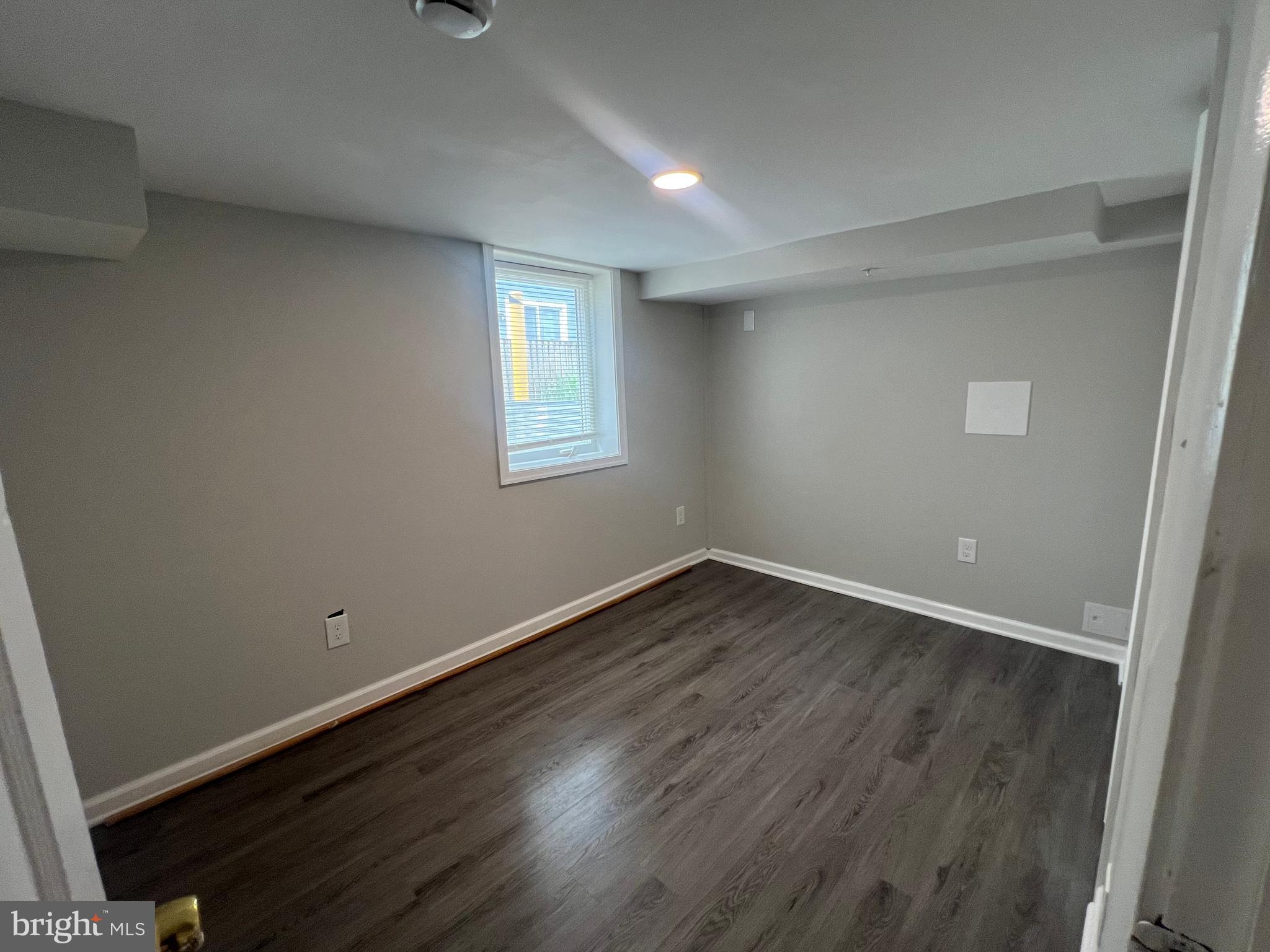 805 Spa Road Annapolis, MD 21401 - Photo 45 of 47 an empty room with wooden floor and windows