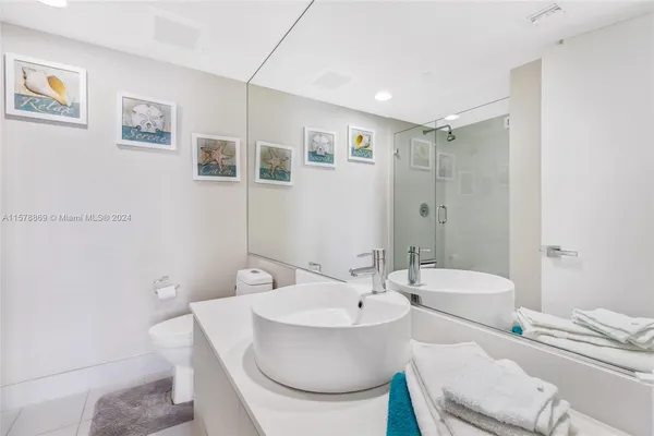 a bathroom with a sink toilet and a mirror