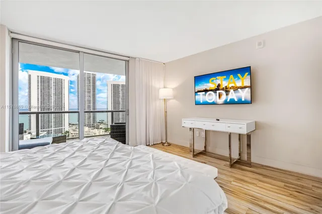 a bedroom with a bed and a flat screen tv