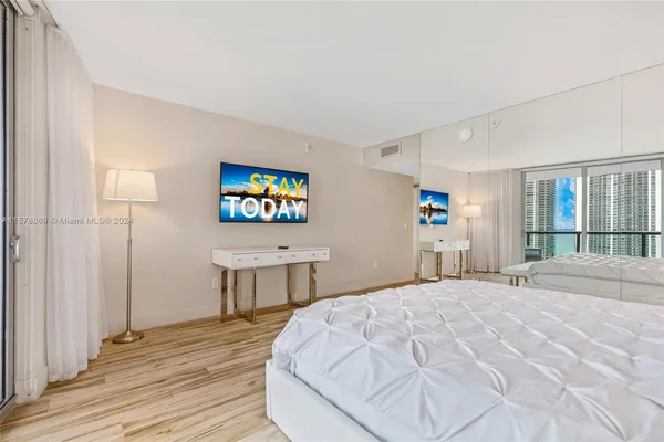 a bedroom with a bed and a table