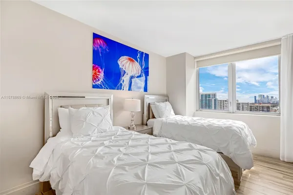 a bedroom with double bed and a large window
