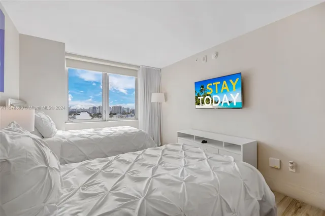a bedroom with a bed and glass windows