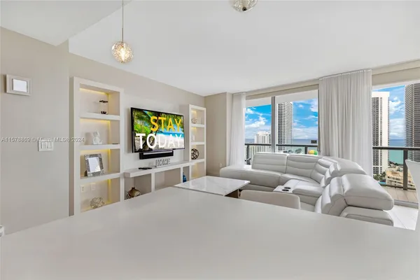 a living room with furniture and a flat screen tv