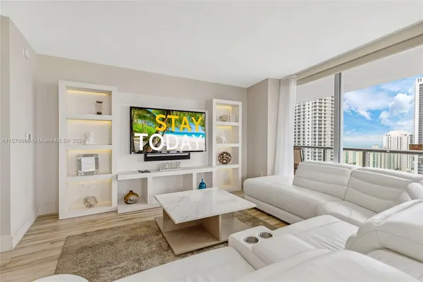 a living room with furniture and a flat screen tv