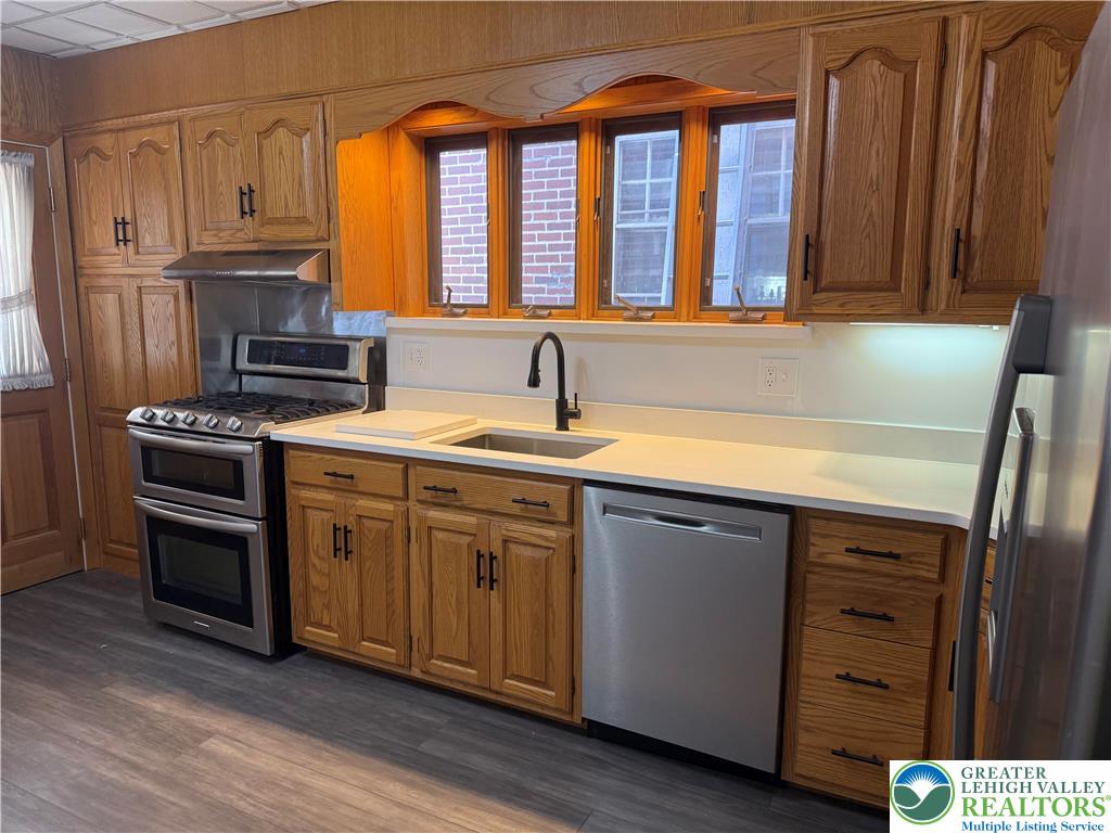 2014 Green Street Allentown, PA 18104 - Photo 11 of 14 a kitchen with stainless steel appliances granite countertop a sink a stove and a refrigerator
