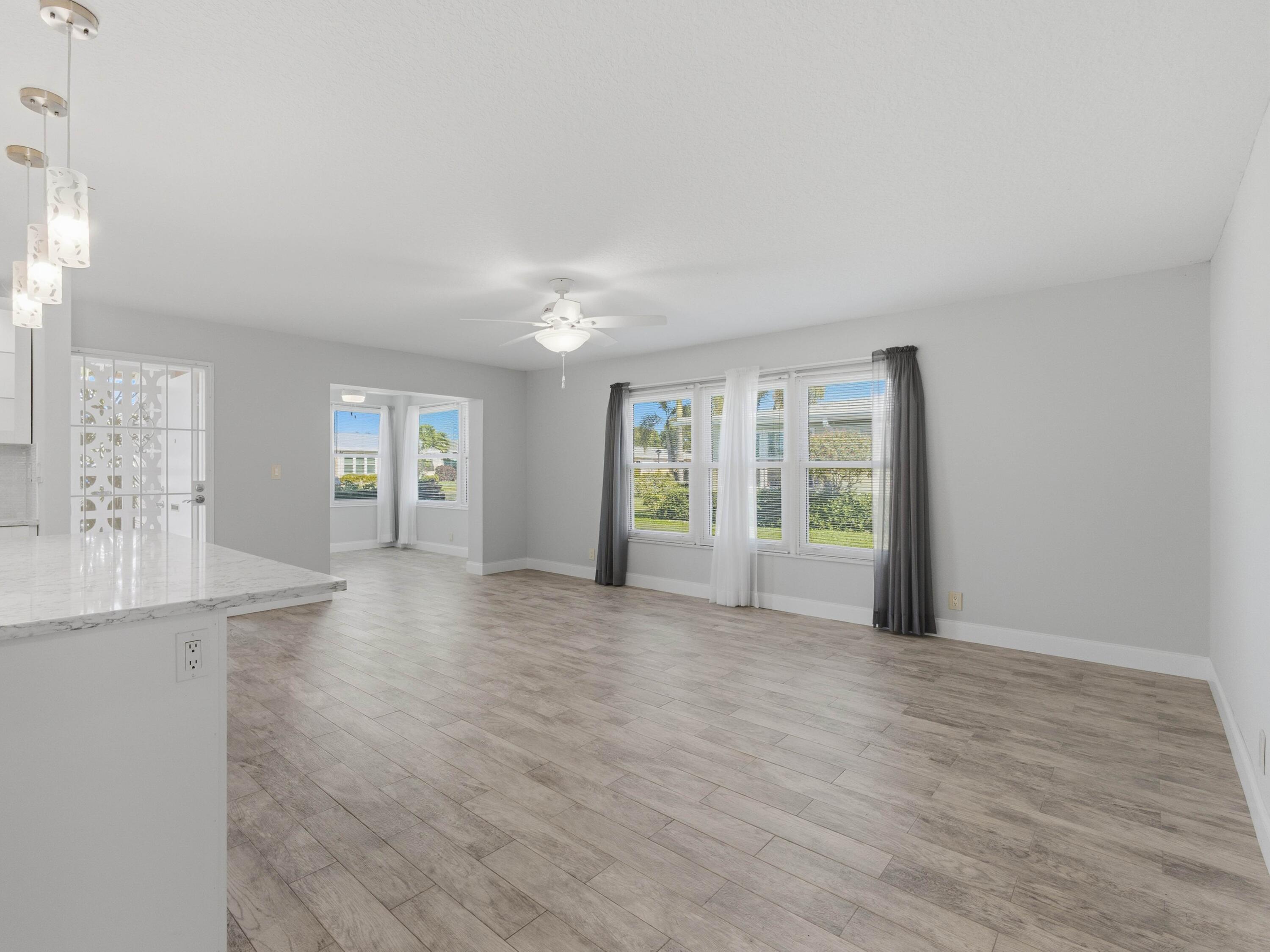 270 High Point Boulevard, Unit A Boynton Beach, FL 33435 - Photo 12 of 44 wooden floor in an empty room with a window