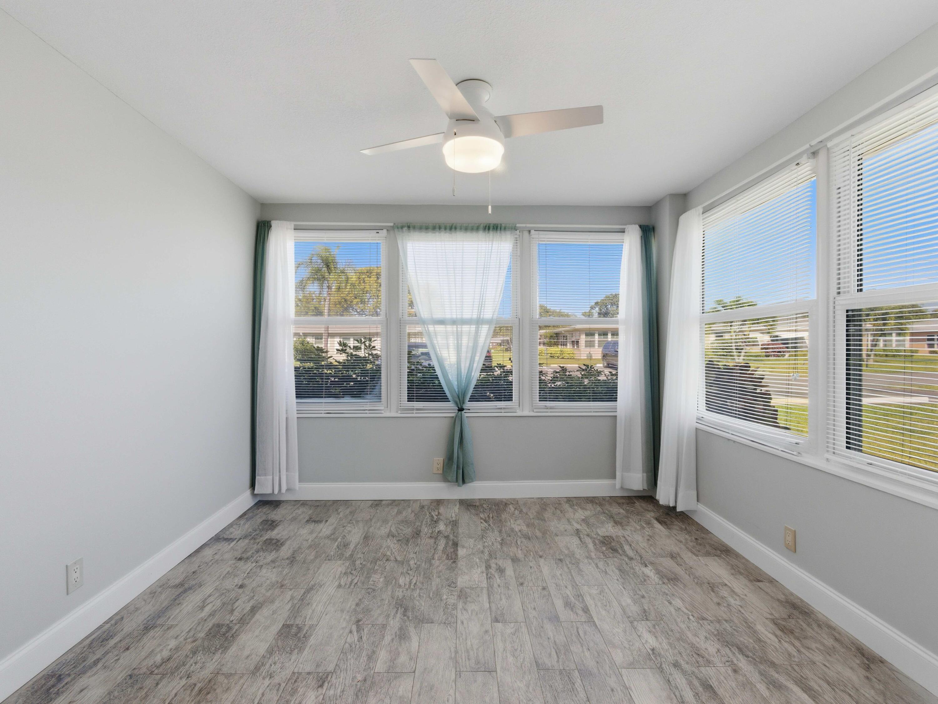 270 High Point Boulevard, Unit A Boynton Beach, FL 33435 - Photo 14 of 44 a view of empty room with wooden floor and fan