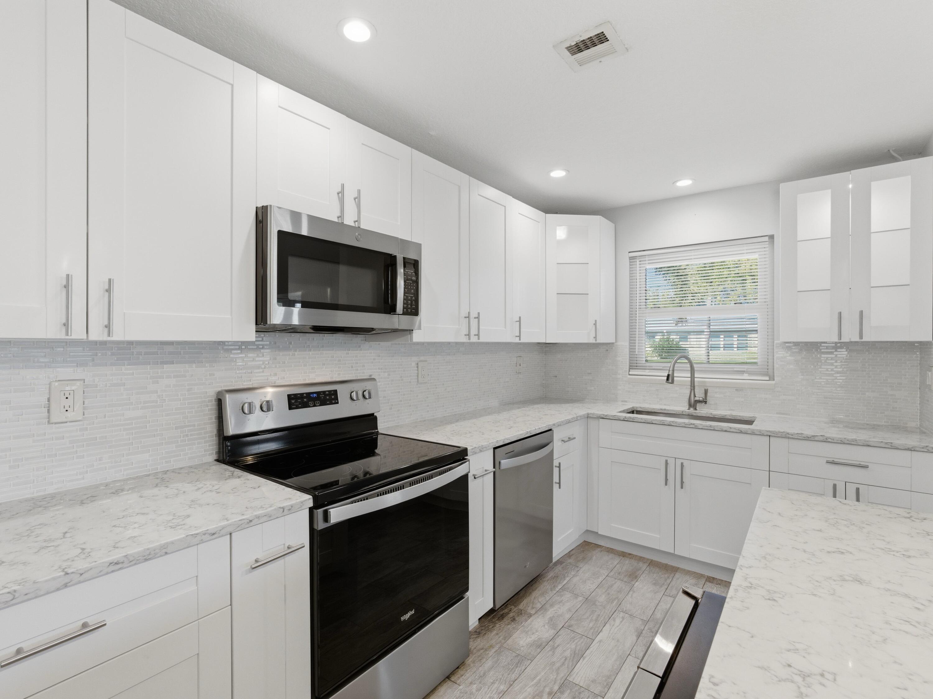270 High Point Boulevard, Unit A Boynton Beach, FL 33435 - Photo 20 of 44 a kitchen with a sink stove and microwave