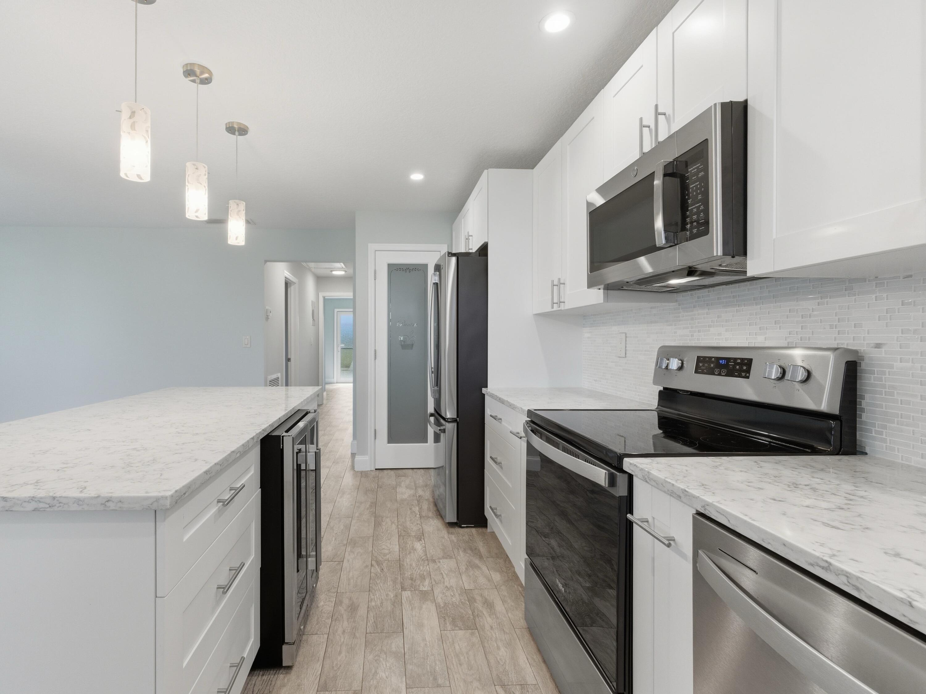 270 High Point Boulevard, Unit A Boynton Beach, FL 33435 - Photo 22 of 44 a kitchen with a stove microwave and refrigerator