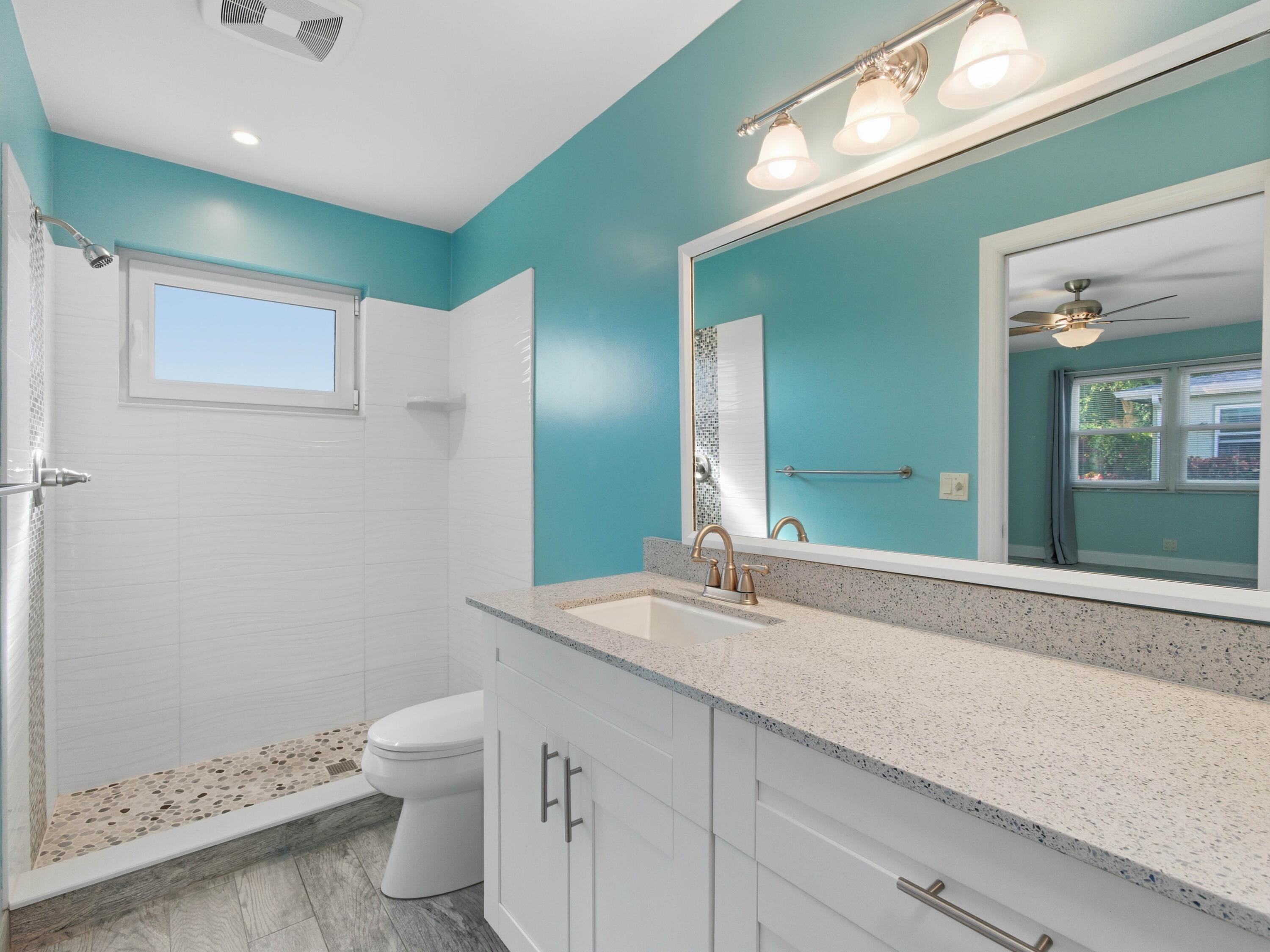270 High Point Boulevard, Unit A Boynton Beach, FL 33435 - Photo 32 of 44 a bathroom with a sink and a mirror