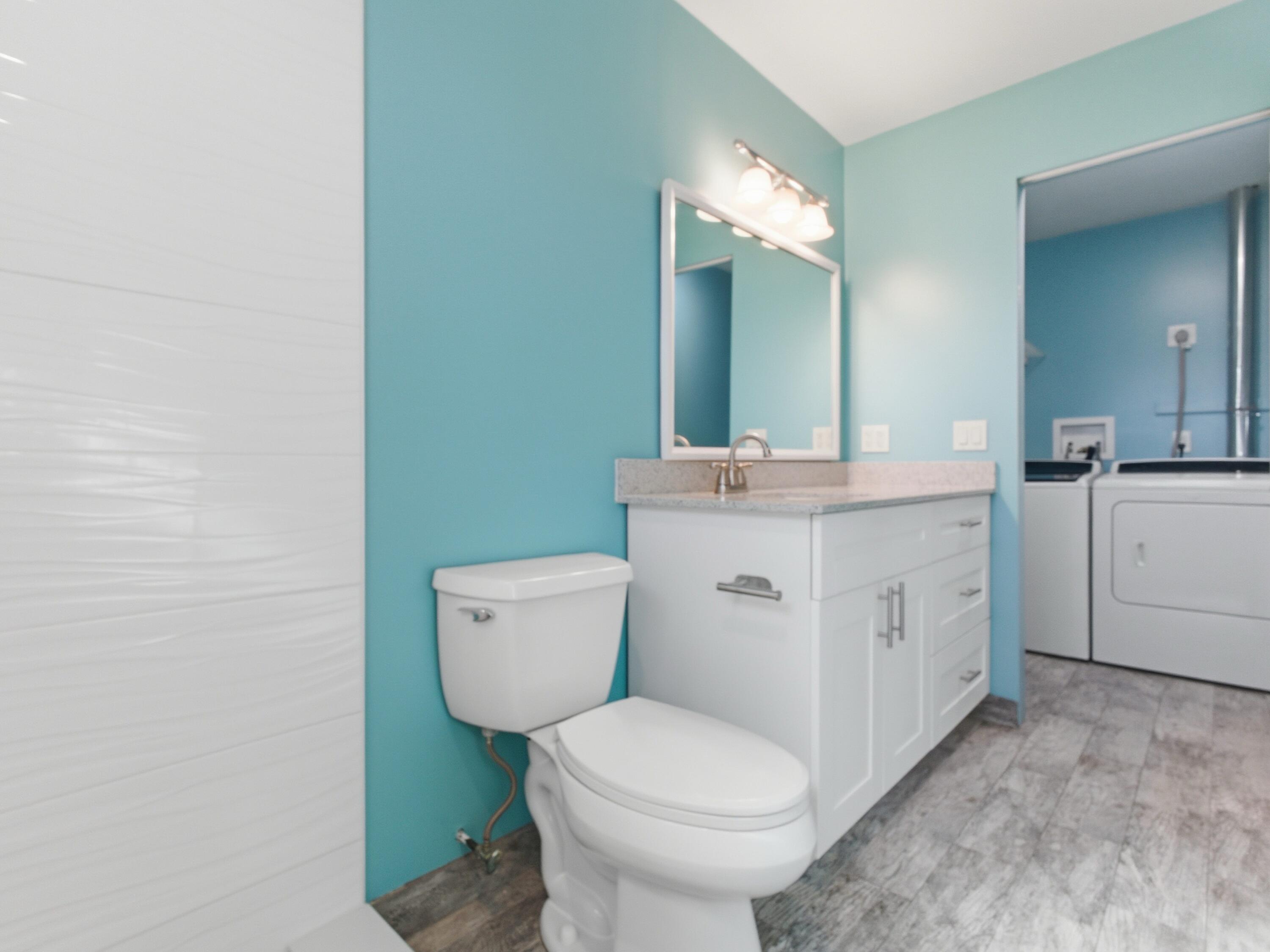 270 High Point Boulevard, Unit A Boynton Beach, FL 33435 - Photo 33 of 44 a bathroom with a toilet sink and mirror