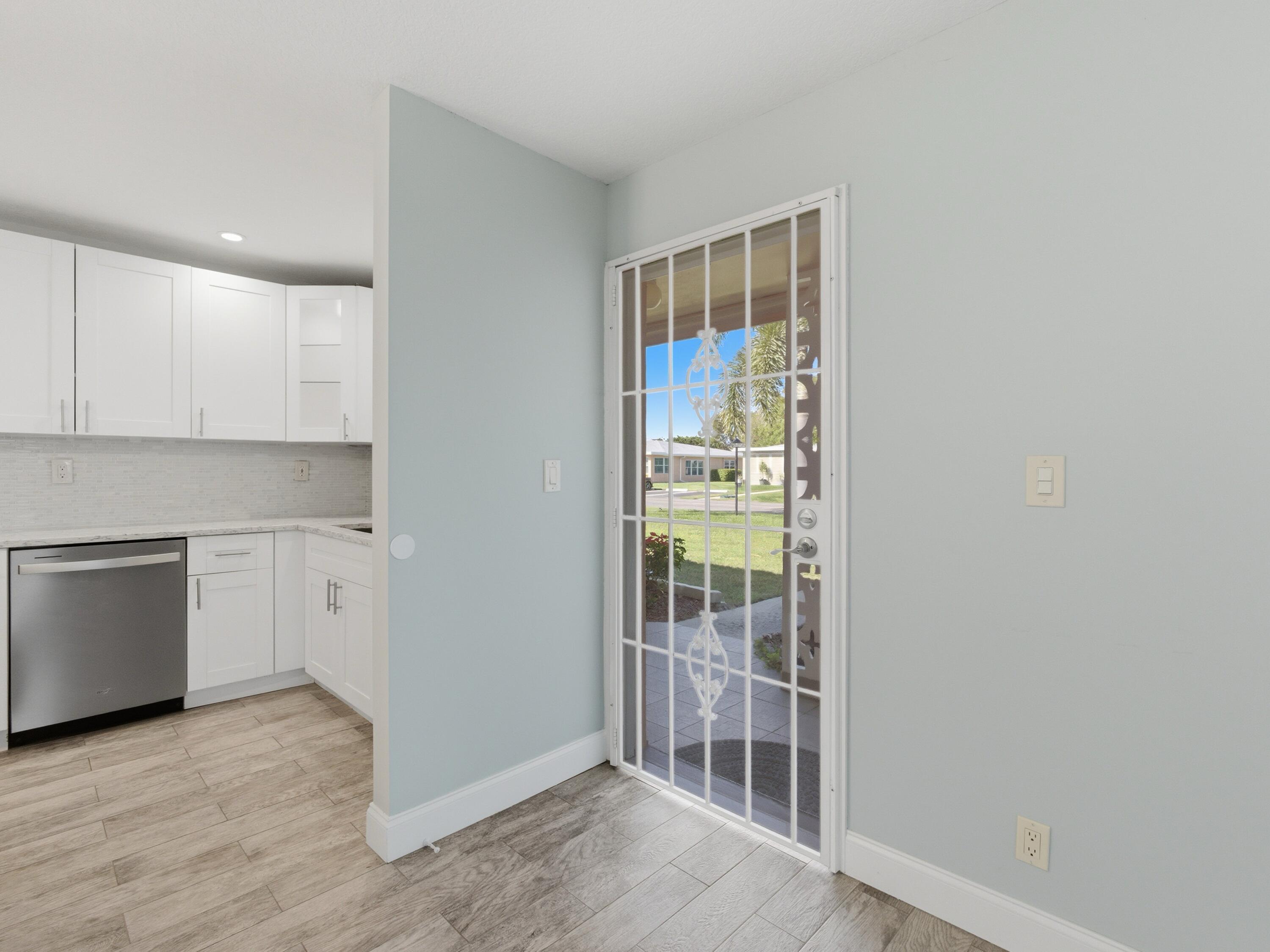 270 High Point Boulevard, Unit A Boynton Beach, FL 33435 - Photo 5 of 44 wooden floor in an empty room and a kitchen