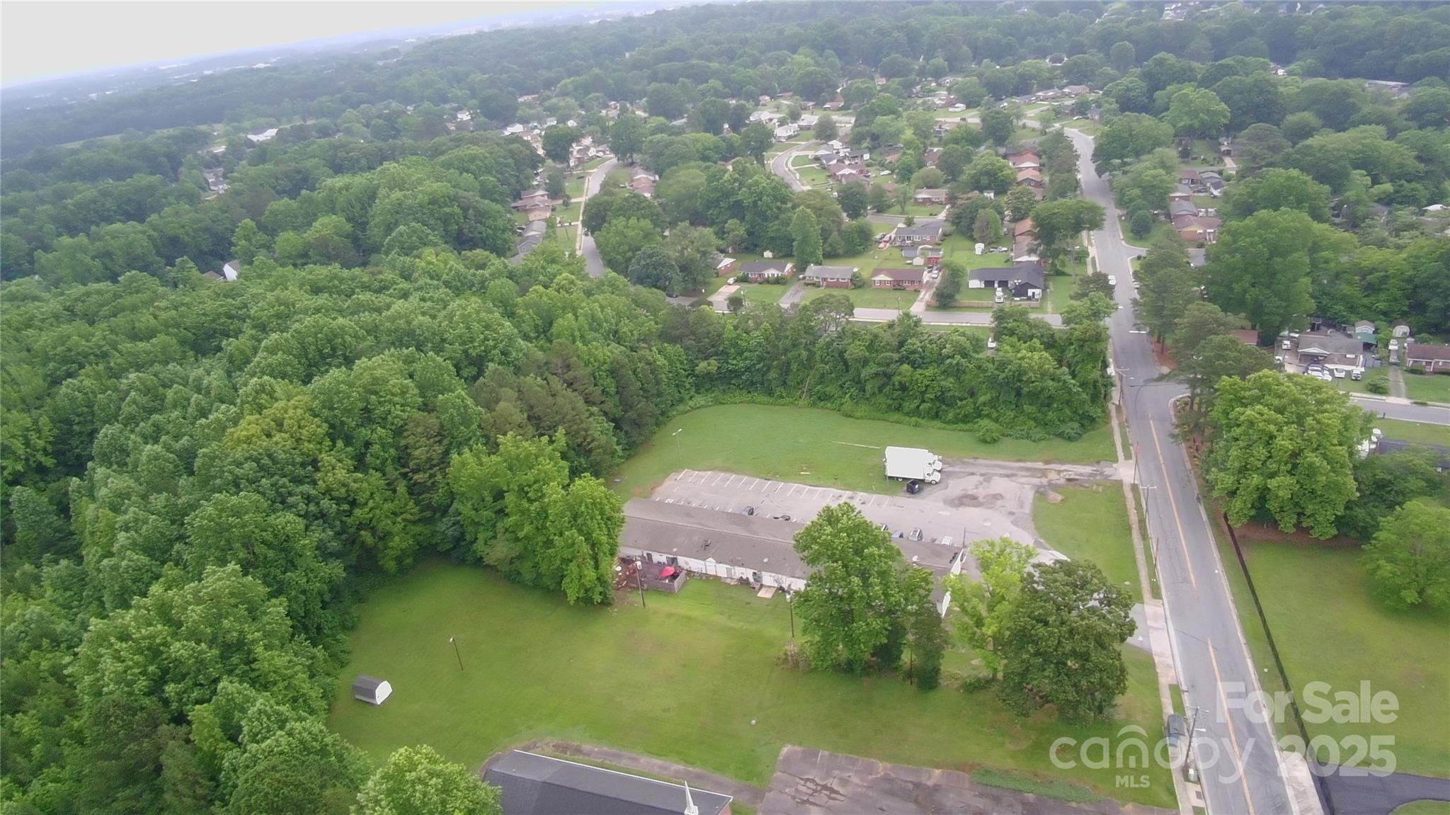 9163 Trinity Road Charlotte, NC 28216 - Photo 3 of 7 an aerial view of a house with yard swimming pool and outdoor seating