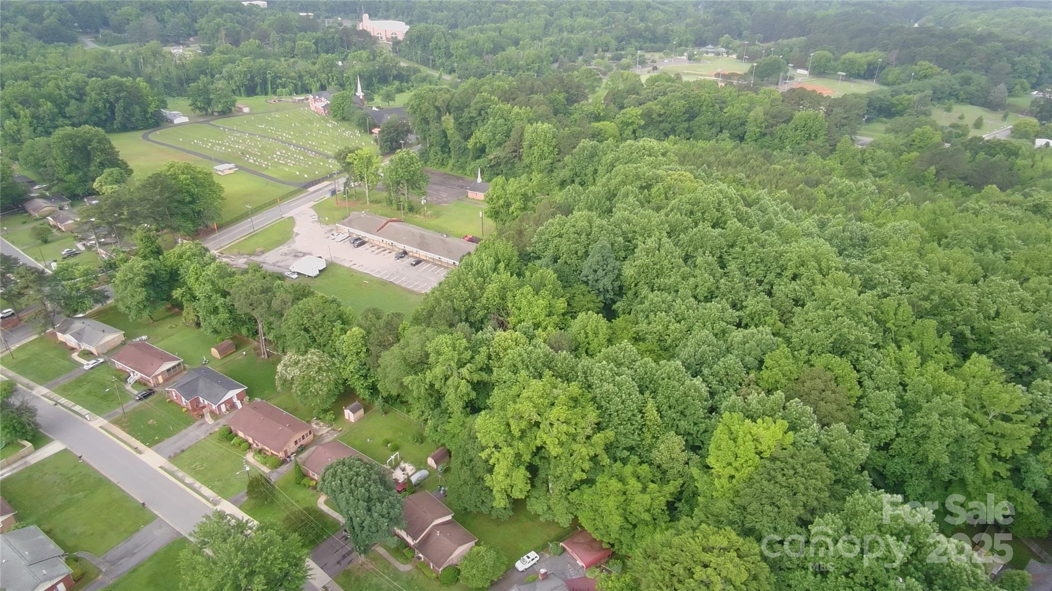 9163 Trinity Road Charlotte, NC 28216 - Photo 4 of 7 an aerial view of a house with a yard