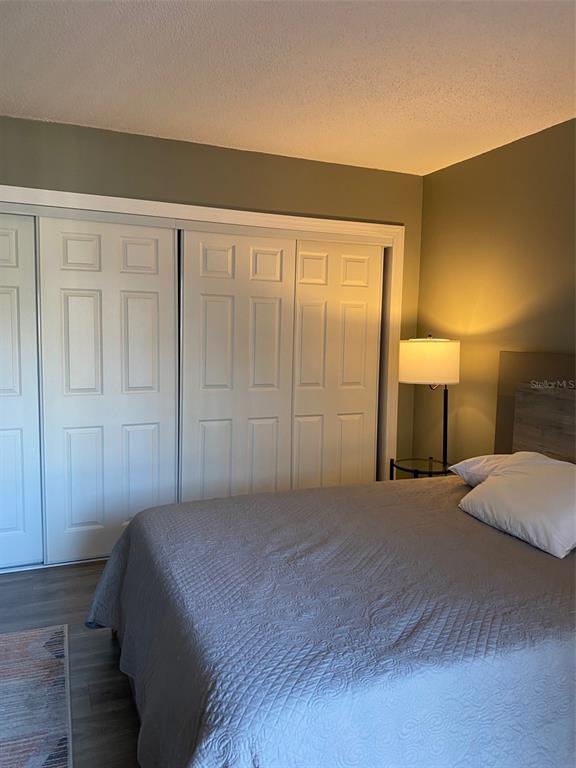 2209 Belleair Road, Unit C21 Clearwater, FL 33764 - Photo 13 of 23 a bedroom with a bed and a lamp