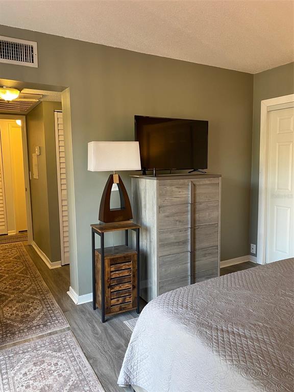 2209 Belleair Road, Unit C21 Clearwater, FL 33764 - Photo 14 of 23 a bedroom with a bed and a television