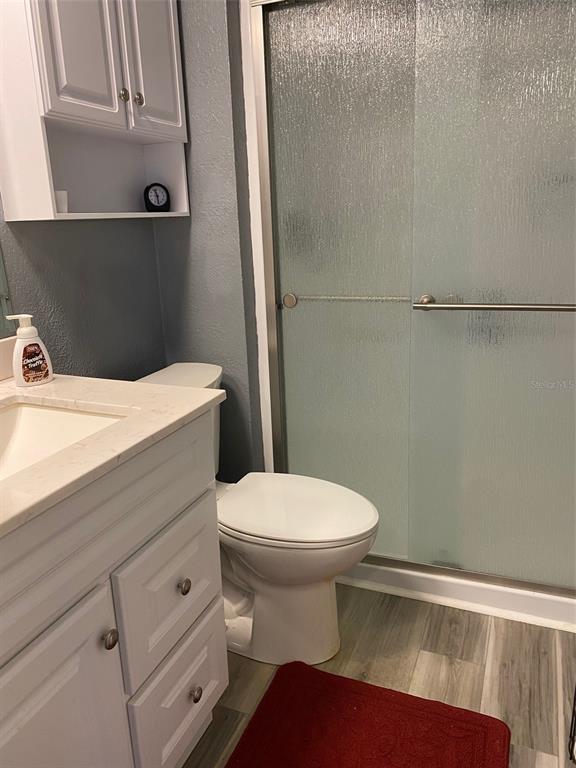 2209 Belleair Road, Unit C21 Clearwater, FL 33764 - Photo 15 of 23 a bathroom with a sink a toilet and a mirror