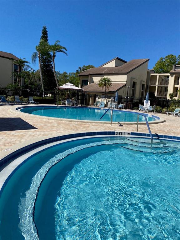 2209 Belleair Road, Unit C21 Clearwater, FL 33764 - Photo 22 of 23 a view of a house with a backyard porch and sitting area